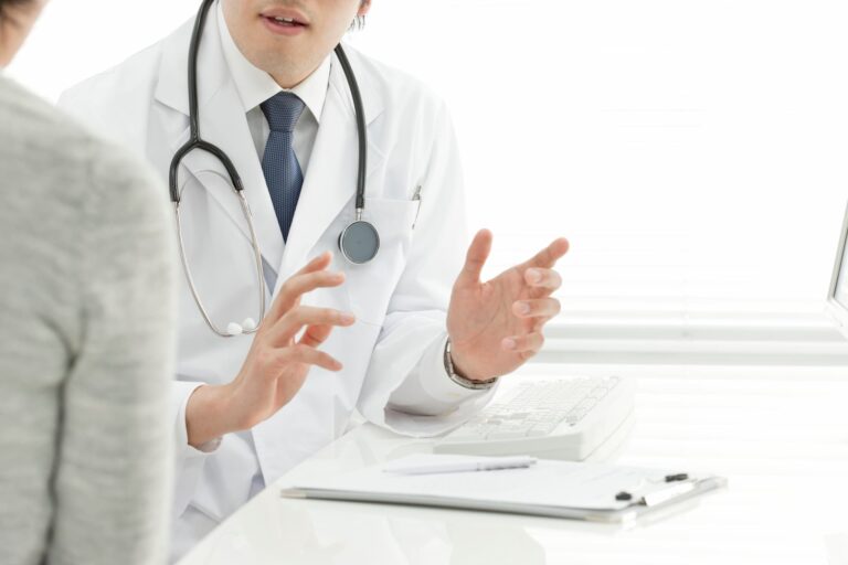 A dermatologist explaining acne treatment options to a patient during their first visit to the clinic.
